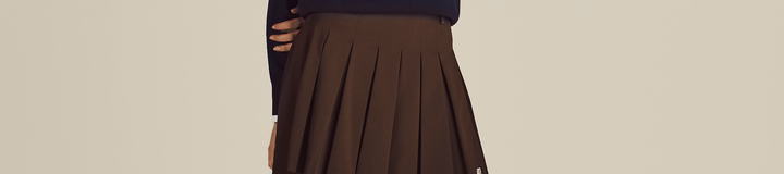 STUDIO SEOUL HIGH-LOW PLEATED SKIRT