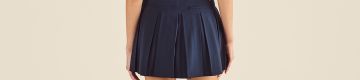 STUDIO SEOUL LOGO BANDING PLEATED SKIRT