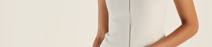 GEMMA ZIP SLEEVELES POLO